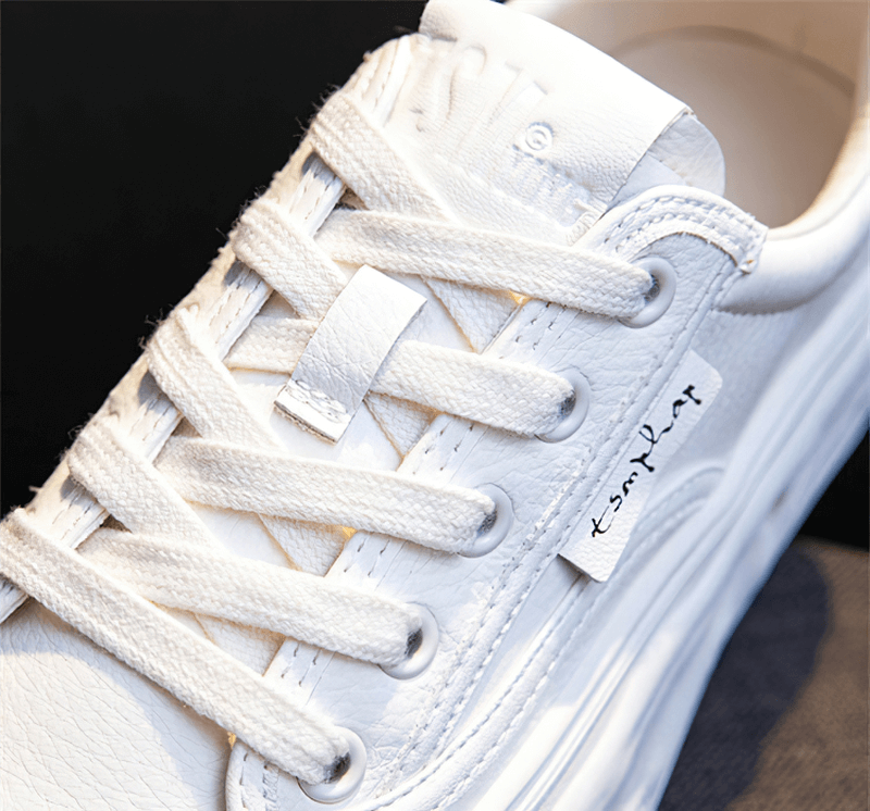 Close-up of white sports women's round toe lace-up sneaker SF0972 with thick sole featuring split leather and lace-up closure.